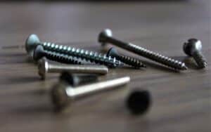 silver screw on brown wooden table